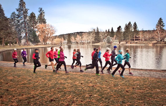 A group of people jogging near the lake