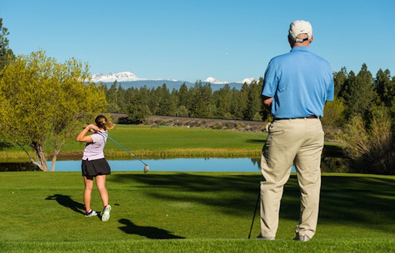 Two individuals playing golf in Old Black Nine