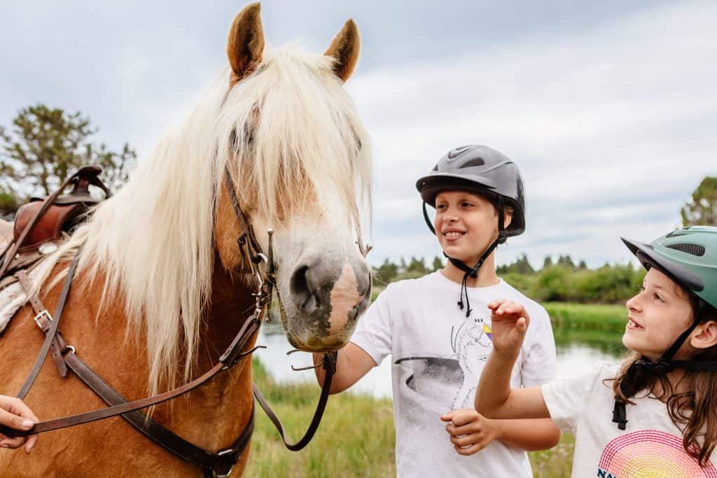 2021-06-22-VCO-Sunriver-37-large Two children pet horses at Sunriver Stables in Central Oregon