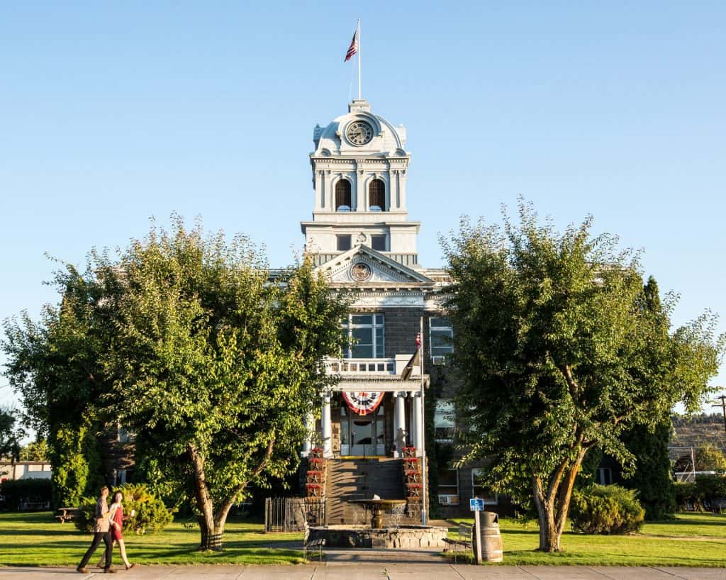 outdoor-adventure travel photography by steve heinrichs_-8-large Couple walks in front of the historic Crook County Courthouse in Prineville, Oregon