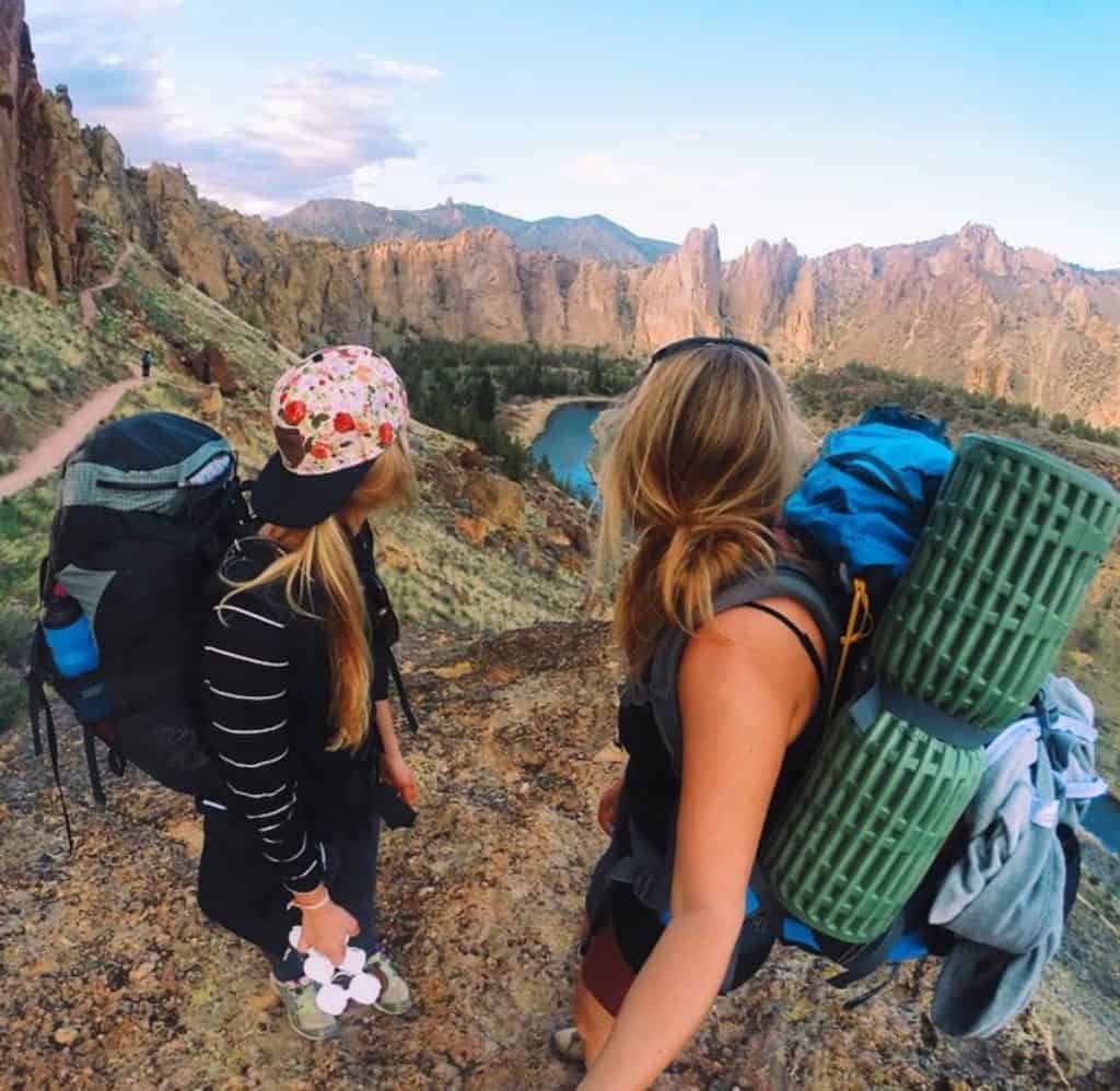 Two backpackers look over Smith Rock State Park and the Crooked River in Terrebonne, Oregon.
