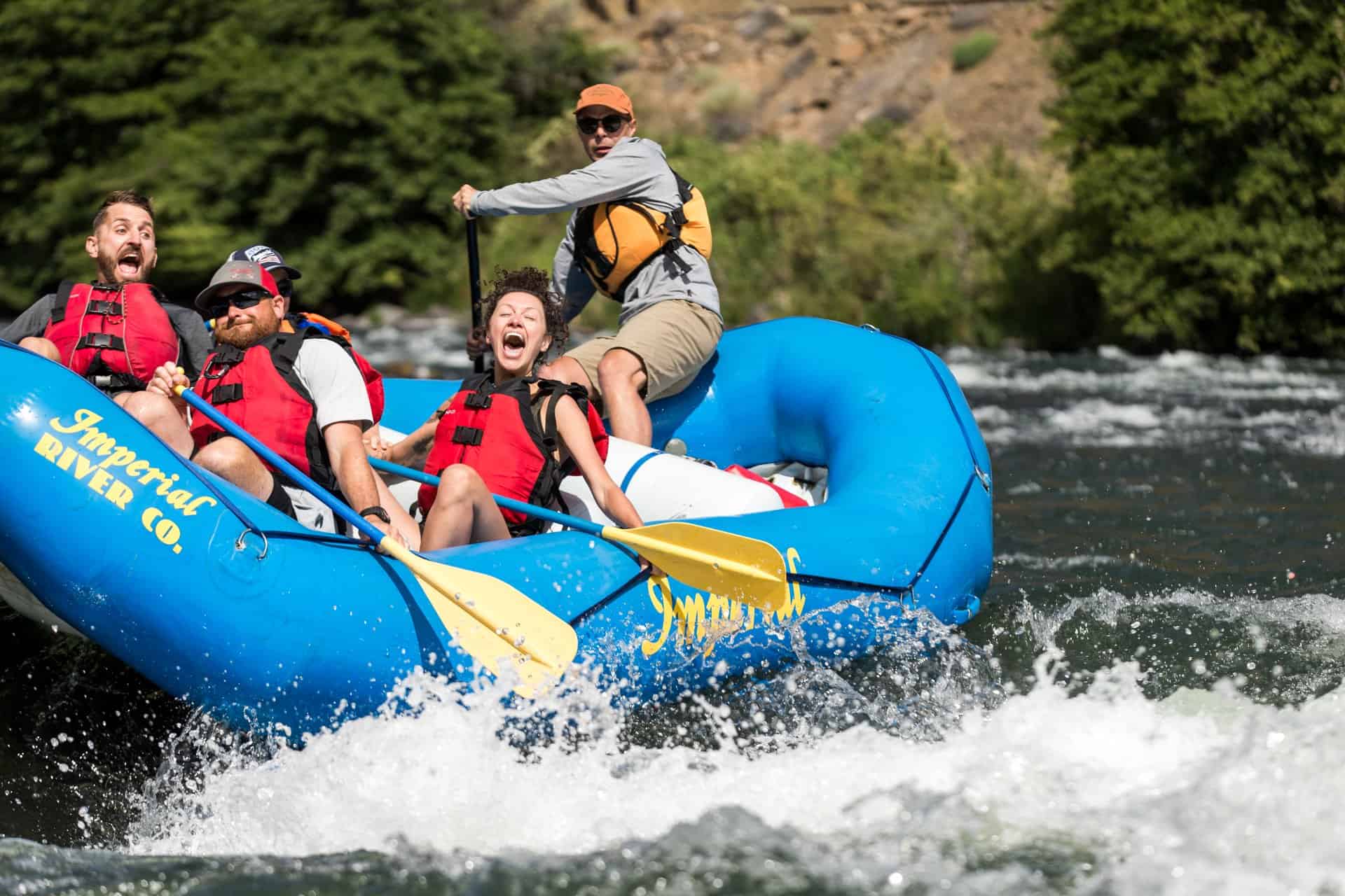 outdoor-adventure lifestyle photography by steve heinrichs_-32-large Group of people laughing on raft as it goes through white water in Maupin, Oregon