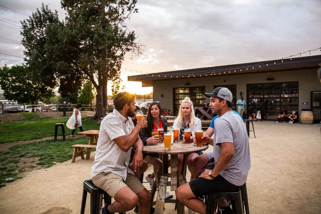 steve-heinrichs-photography-86-large 5 people sitting around an outdoor bar table drinking beer