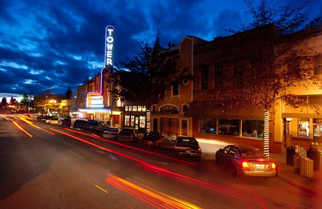 Cars drive along Wall Street in front of the Tower Theatre in Bend, Oregon.
