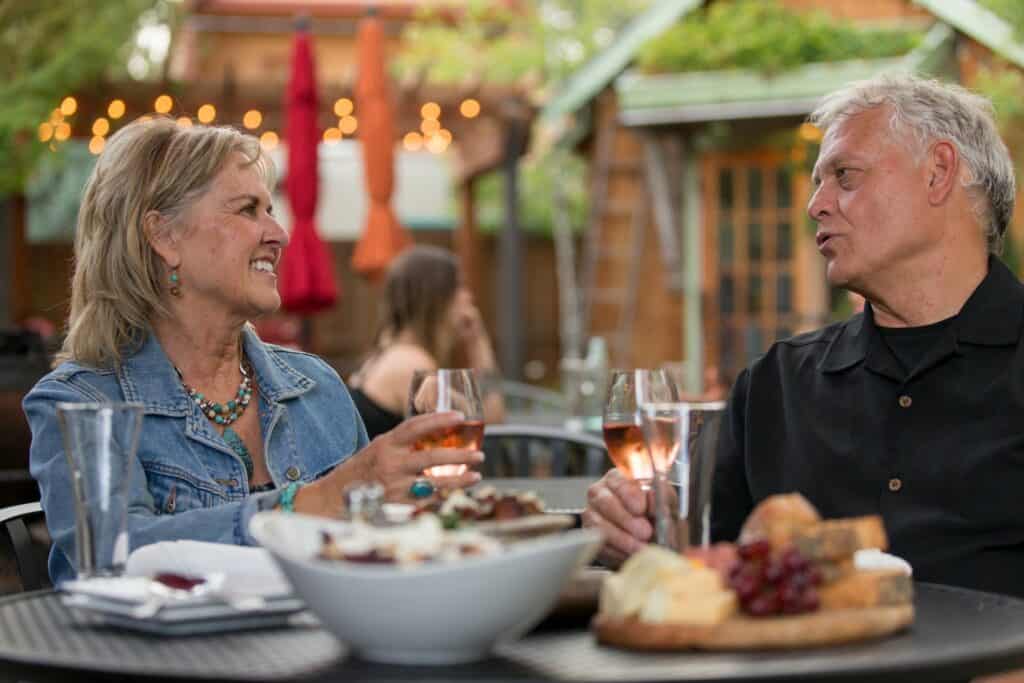 bend oregon lifestyle photography by steve heinrichs_-63-large Caucasian couple in their 60s drinks wine outside at the Open Door in Sisters, Oregon