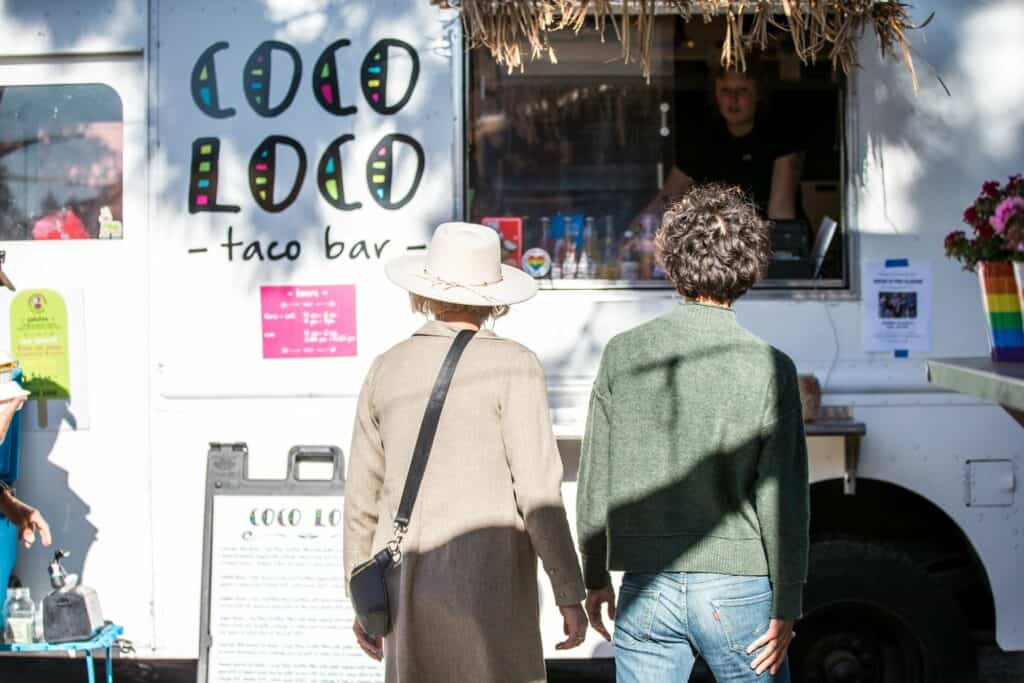 steve-heinrichs-photography-131-large two women walking up to the Coco Loco taco truck