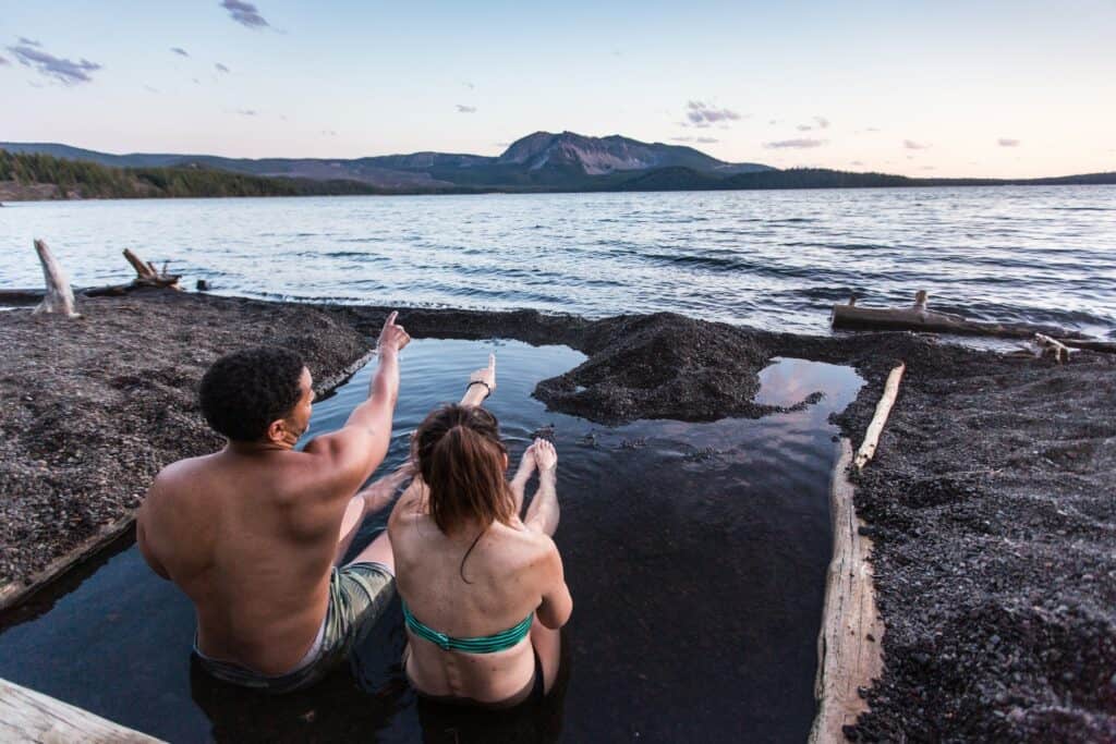 outdoor-adventure travel photography by steve heinrichs_-47-large Couple sits in hot spring next to the lake in Newberry National Volcanic Monument