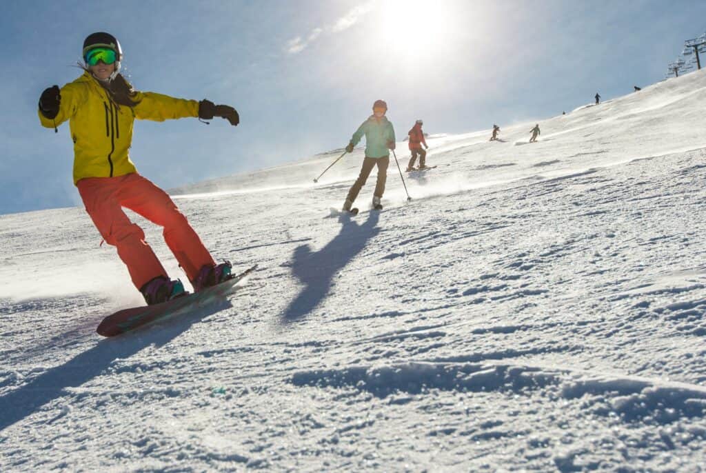 photography by steve heinrichs-22-large Snowboarders and skiers going downhill on Mt. Bachelor on a sunny day