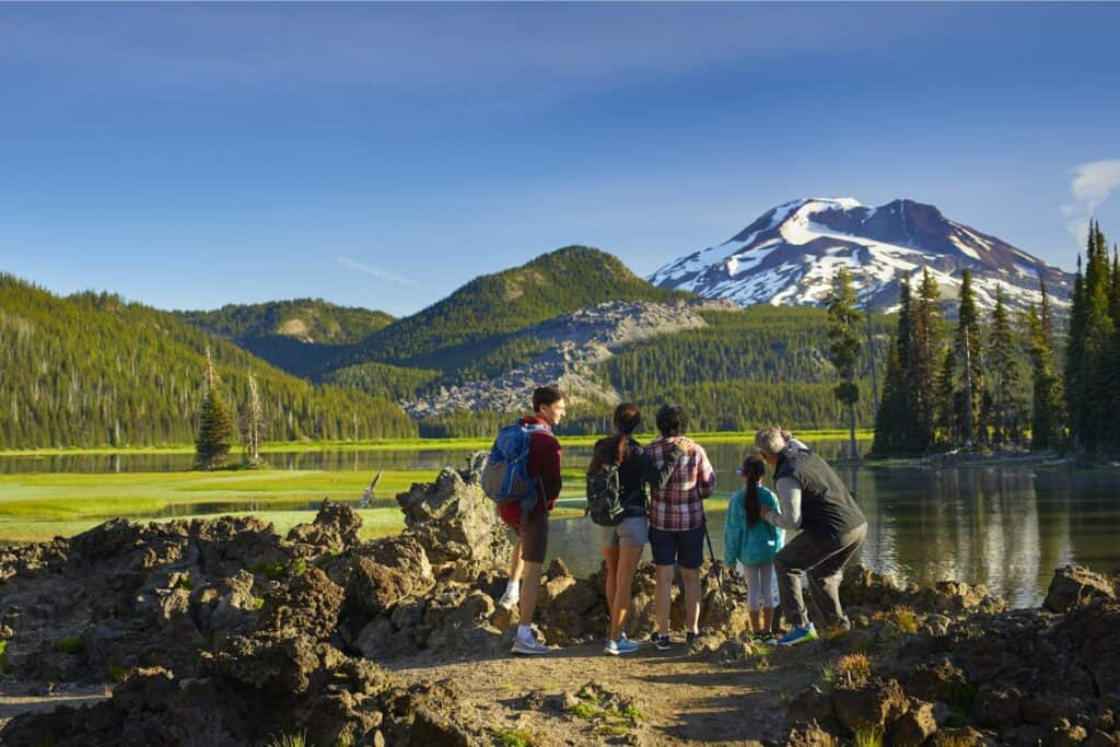 Sparks Lake Hike-large Family of five looks at South Sister at Sparks Lake near Bend, Oregon