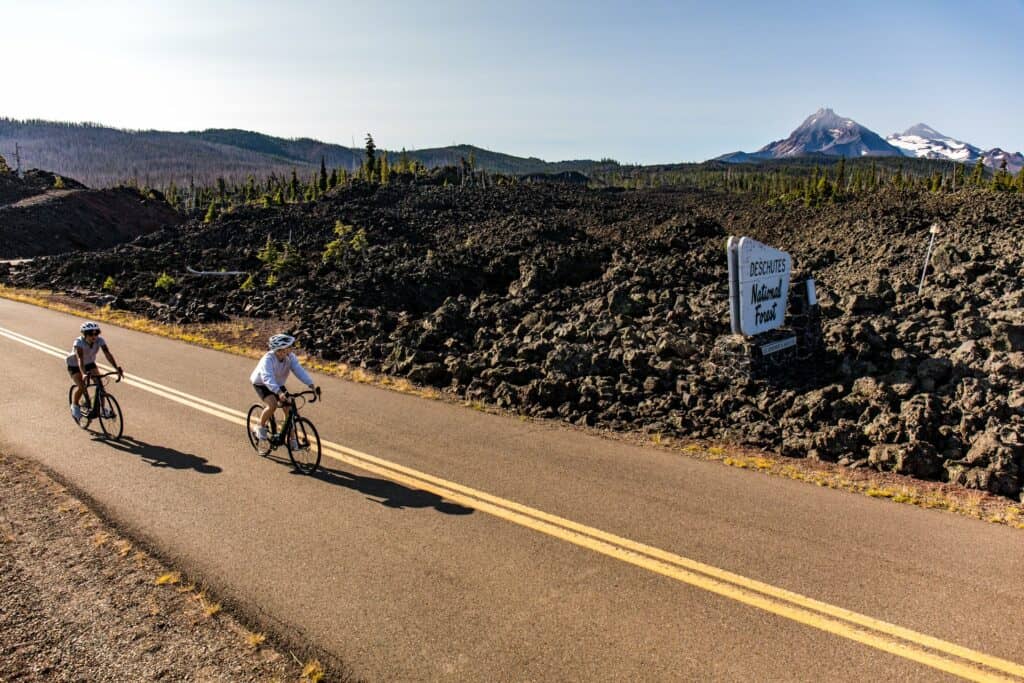 Two women cycling McKenzie Pass near Sisters, Oregon