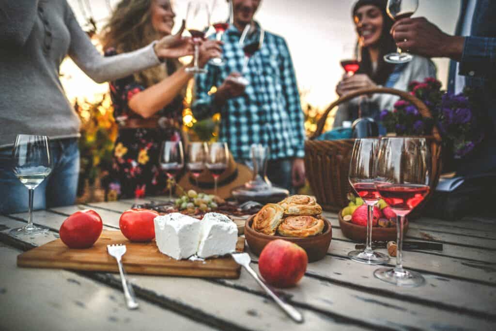 iStock-1066538106-large a group of friends enjoying appetizers and wine in a vineyard