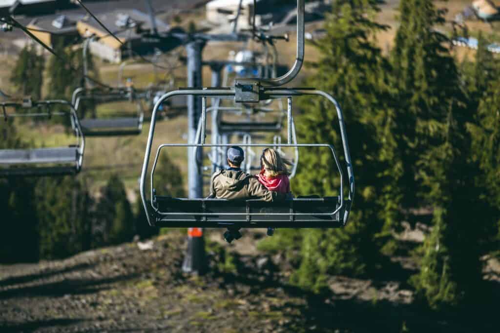 Brew_With_A _View_7_21_21_JP-6175 (1) a couple riding the chairlift in the summertime at Mt Bachelor Resort