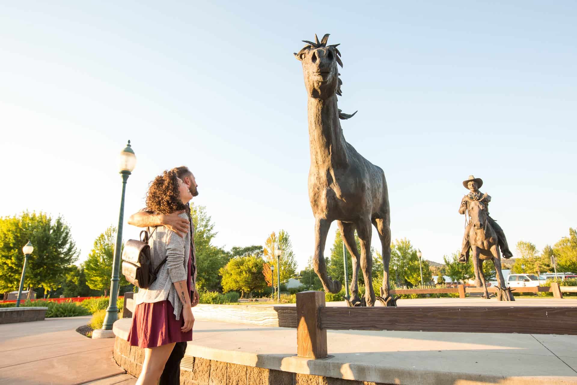 outdoor-adventure travel photography by steve heinrichs_-13-large A man and woman in their 30s looks at a horse statue in Prineville, Oregon