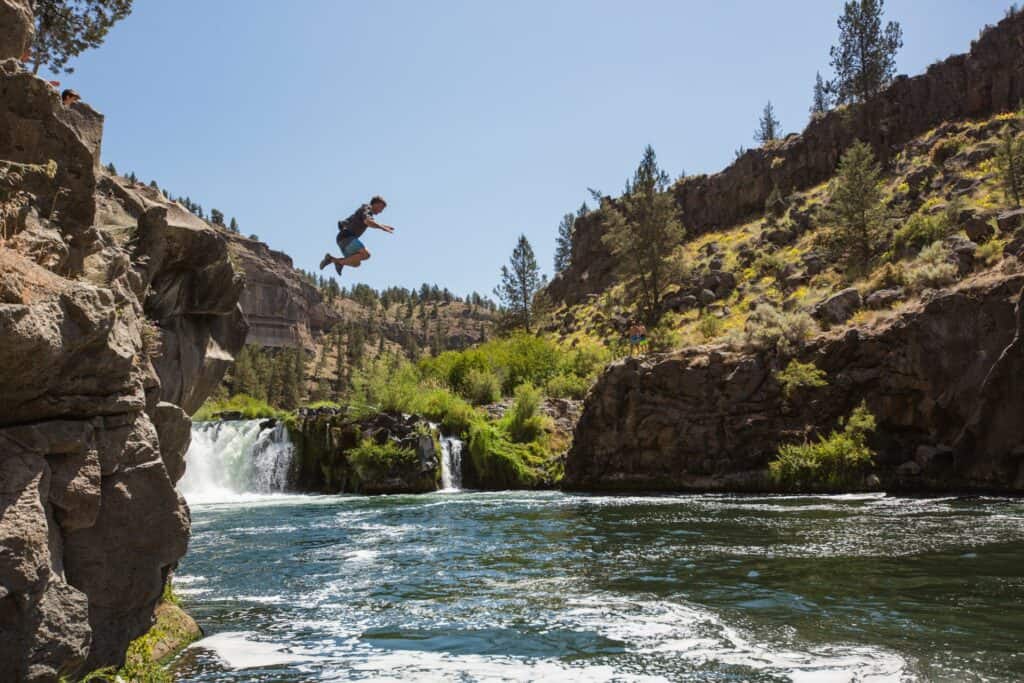 outdoor-adventure travel photography by steve heinrichs_-13-large (1) Man jumps off rocks at Steelhead Falls near Redmond, Oregon.