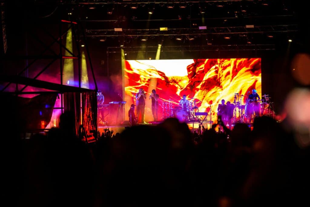 musicians performing on stage at night at the Les Schwab Amphitheater in Bend