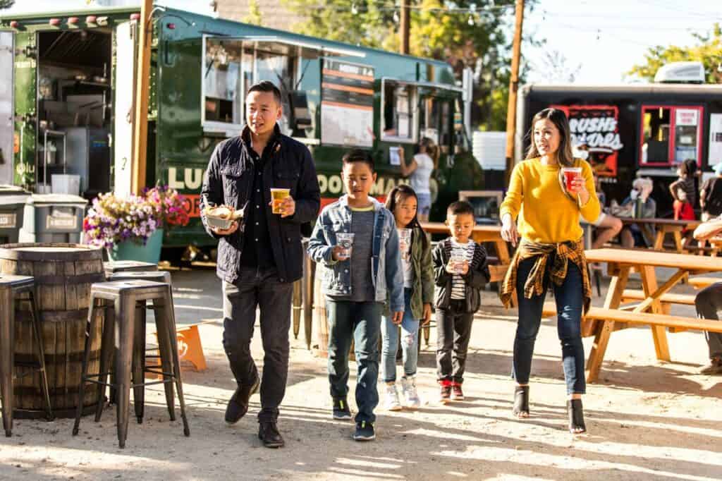 steve-heinrichs-photography-207-medium a family walks by the food carts to a table to enjoy their food