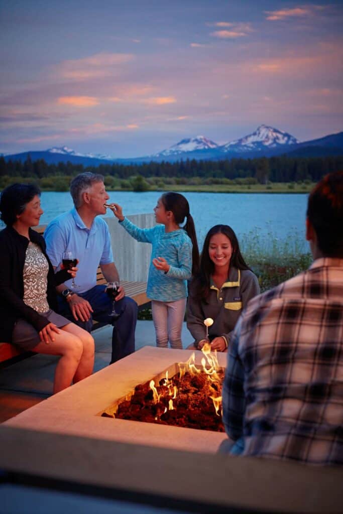 BBR_Dine_Fam_20180620_COVA_Smores_3707_ad98rgb_fullsize (1) a family eats smores by the firepit at sunset at Black Butte Ranch