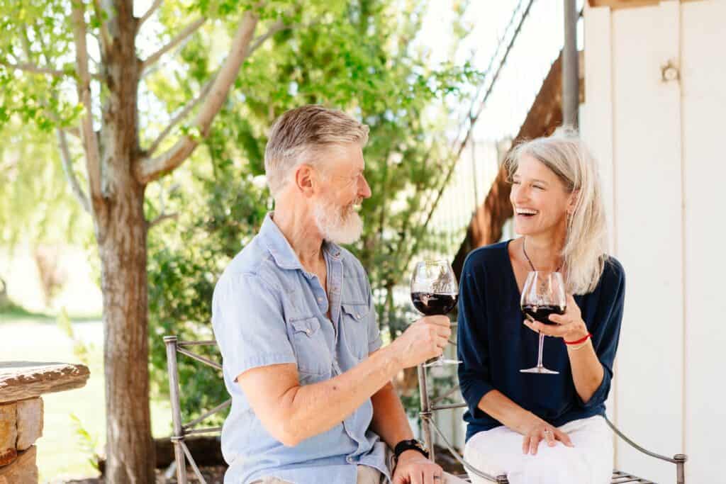 2021-06-24-VCO-Redmond-85-large Man with grey hair and woman with grey hair drinking red wine.