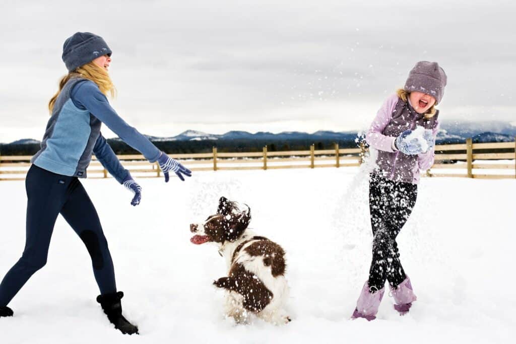 Snowball fight-large Two people ride bikes through Sunriver Resort on a sunny day in Central Oregon