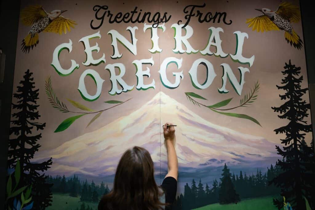 A painter completes a mural. 