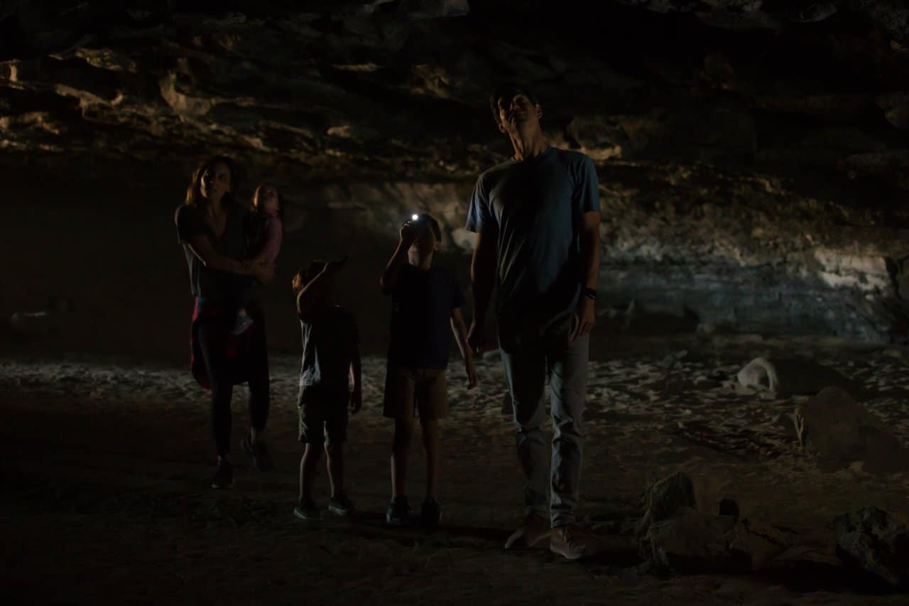 Family inside the Redmond Caves Recreation Site in Redmond, Oregon Family inside the Redmond Caves Recreation Site in Redmond, Oregon