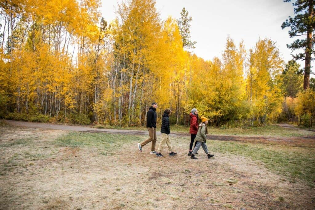 A family walks through Shevlin Park in Bend on a fall day.