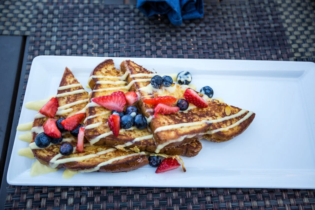A plate of toast with fruit.
