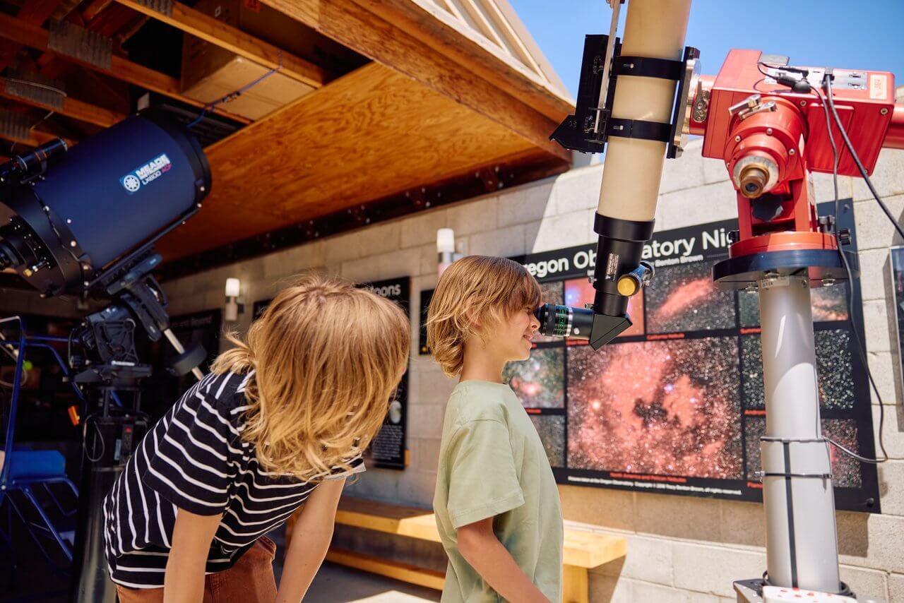 Kids looking through the telescopes at the Sunriver Nature Center & Observatory Kids looking through the telescopes at the Sunriver Nature Center & Observatory